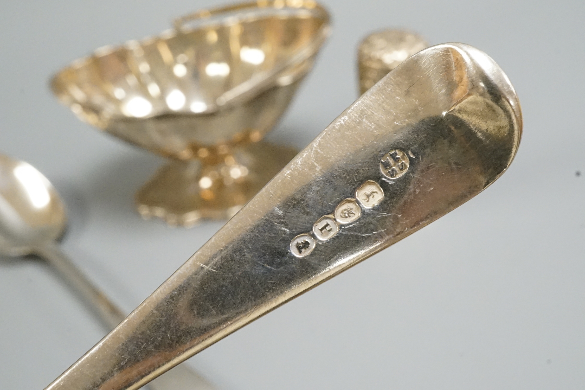 A pair of George III silver Old English pattern tablespoons, London, 1810, a later silver sugar basket and Indian white metal canister.